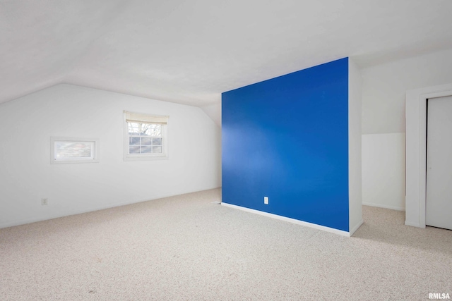 bonus room featuring carpet floors and vaulted ceiling