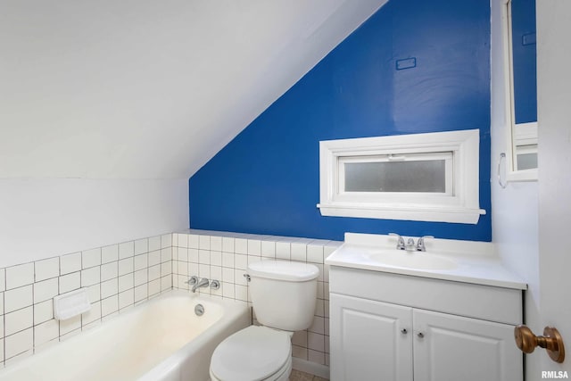 bathroom featuring lofted ceiling, vanity, toilet, and a bathing tub