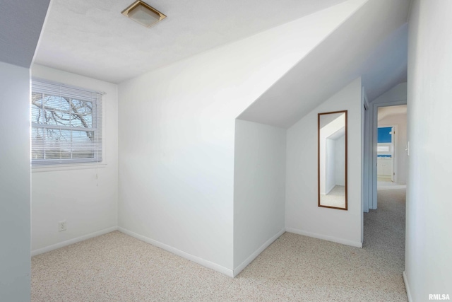 additional living space featuring vaulted ceiling