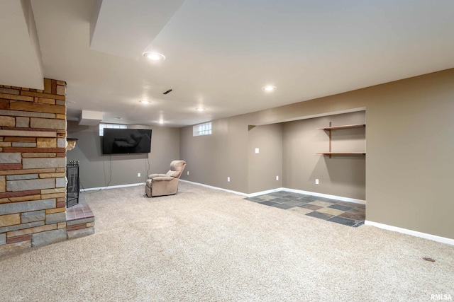 basement with a fireplace and carpet floors