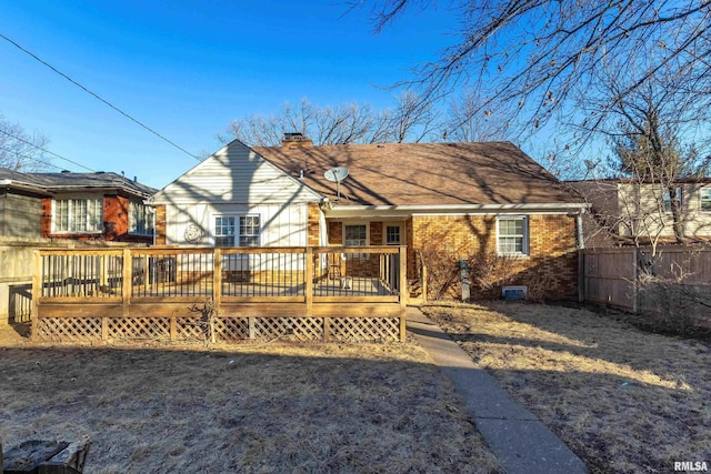 back of house featuring a wooden deck