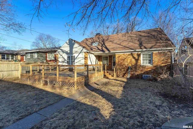 rear view of property featuring a wooden deck