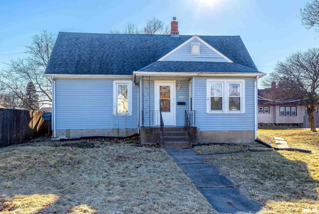 bungalow-style home featuring a front lawn