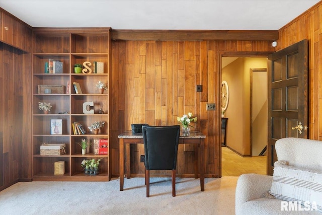 home office with wooden walls and light colored carpet