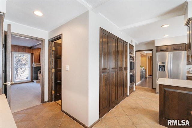 hall featuring recessed lighting, light tile patterned flooring, and ornamental molding