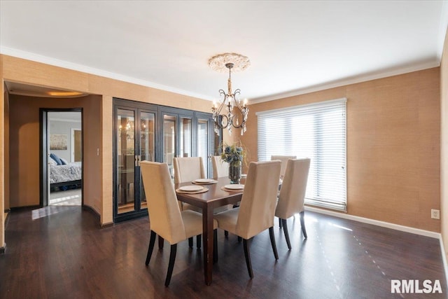 dining space featuring baseboards, dark wood finished floors, french doors, crown molding, and a notable chandelier