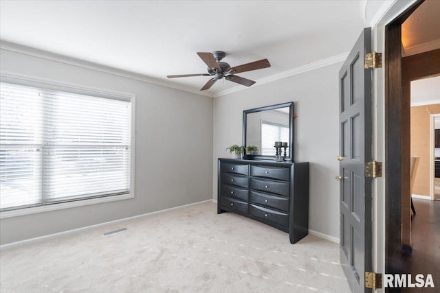 bedroom featuring visible vents, baseboards, light colored carpet, and ornamental molding