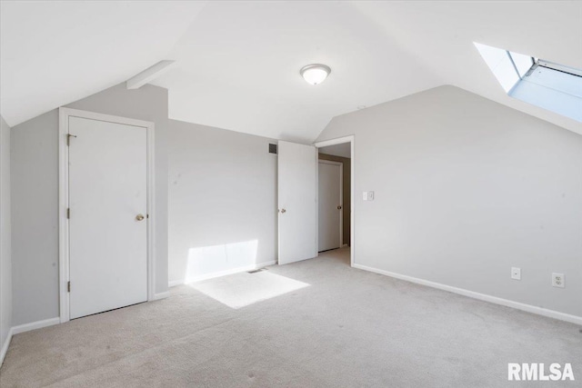 bonus room featuring baseboards, lofted ceiling with skylight, and carpet floors