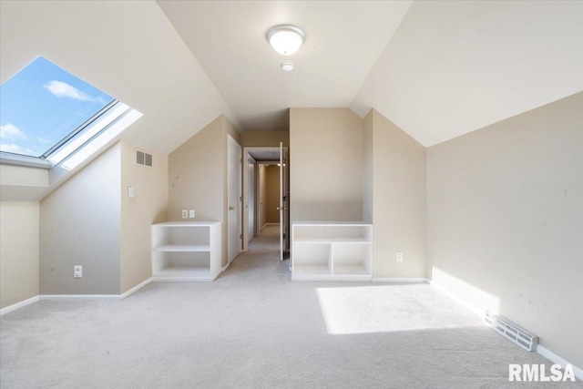 bonus room featuring visible vents, lofted ceiling with skylight, carpet, and baseboards