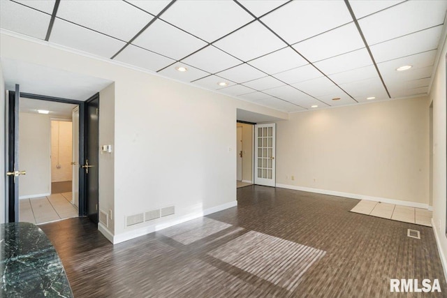 spare room with a drop ceiling, visible vents, baseboards, and recessed lighting