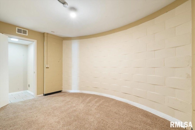 carpeted empty room featuring visible vents and baseboards