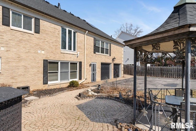 exterior space with fence, a garage, and driveway