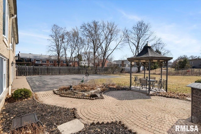 view of yard with a gazebo, a fenced backyard, and a patio area