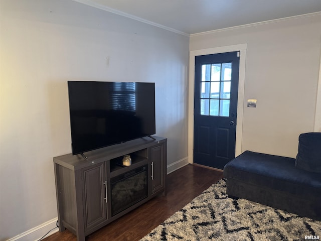 living room featuring dark hardwood / wood-style flooring and crown molding