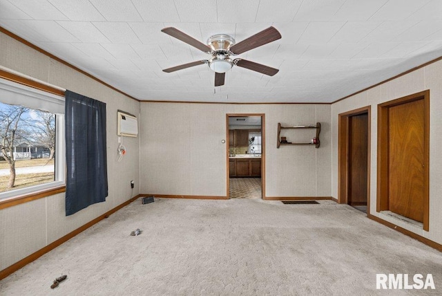 unfurnished bedroom with ceiling fan, light colored carpet, ensuite bathroom, and ornamental molding