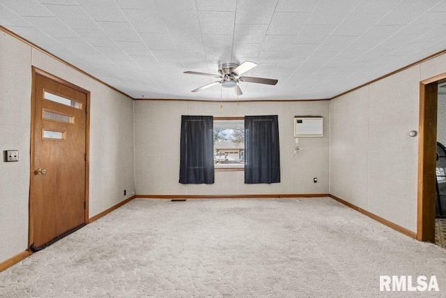 carpeted spare room with ceiling fan, crown molding, and a wall mounted air conditioner