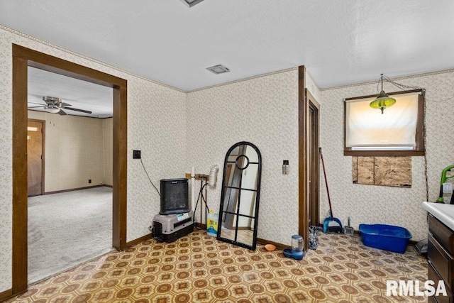 misc room with ceiling fan, light colored carpet, and ornamental molding