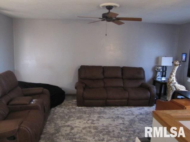 living room featuring ceiling fan and carpet flooring