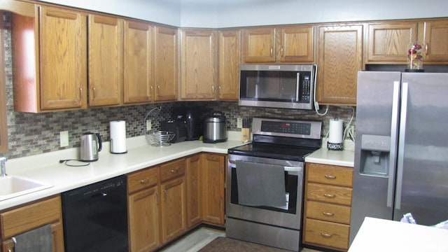 kitchen with stainless steel appliances, tasteful backsplash, and sink