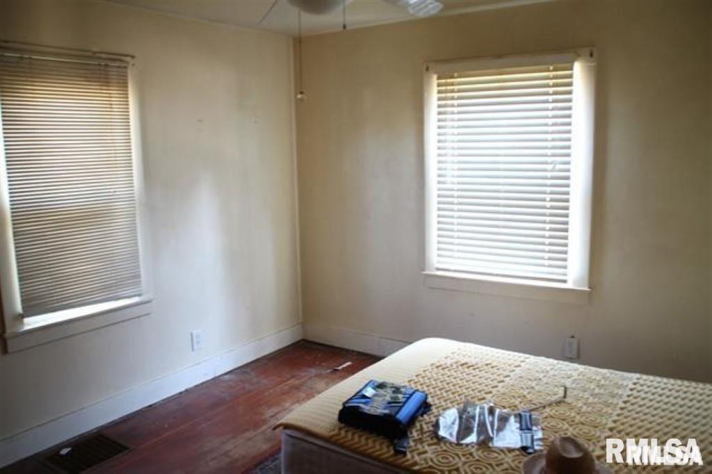 1836 Cody St, Bettendorf, IA 52722 - bedroom with multiple windows and dark hardwood / wood-style flooring