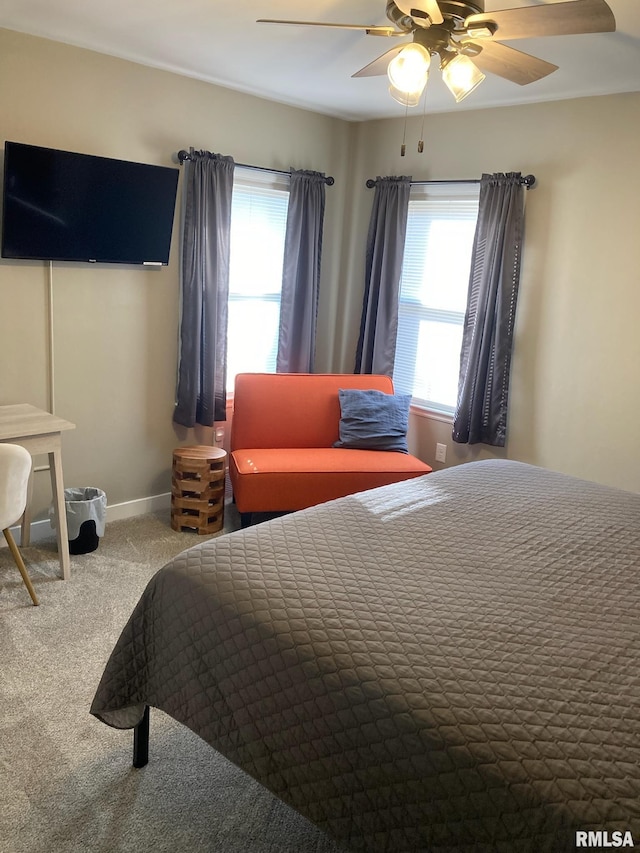 carpeted bedroom with ceiling fan and multiple windows