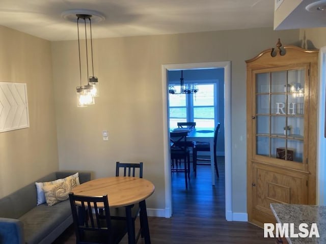 dining area featuring dark wood-type flooring