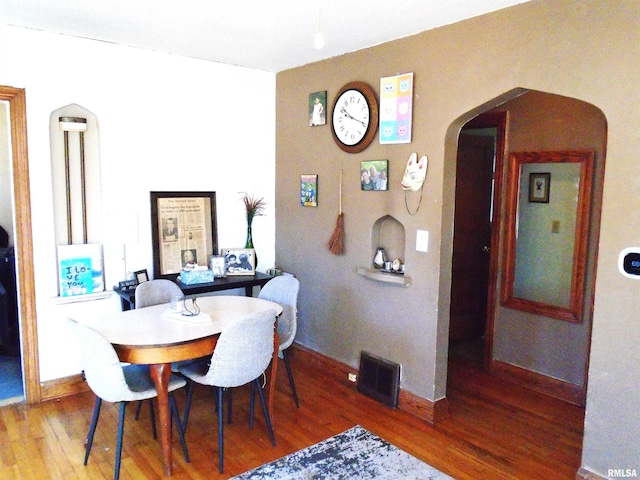 dining area with hardwood / wood-style floors