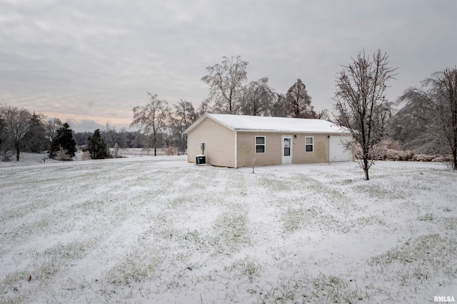 view of snow covered exterior featuring cooling unit