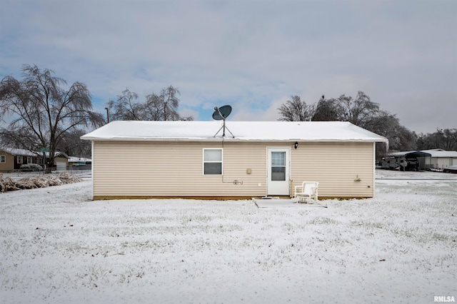 view of snow covered rear of property