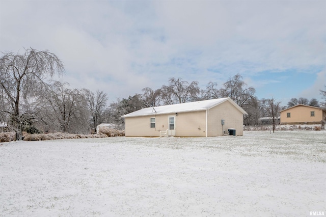 view of snow covered rear of property