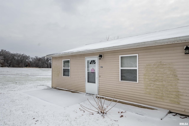 view of snow covered property entrance