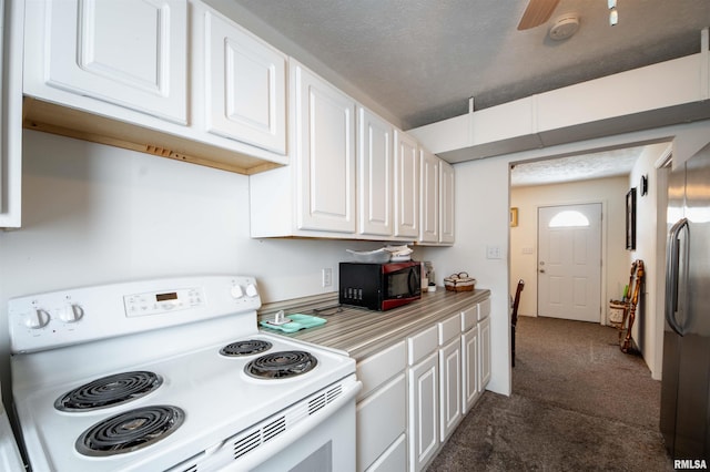 kitchen featuring white cabinetry, white range with electric cooktop, stainless steel refrigerator, ceiling fan, and dark carpet