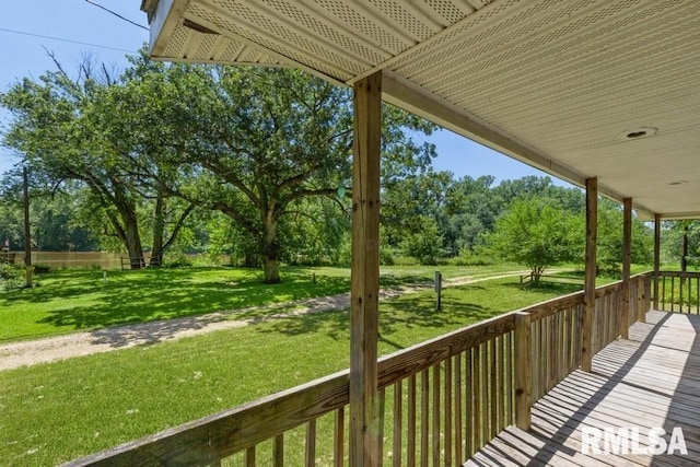 wooden deck featuring a porch and a yard