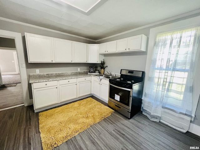 kitchen with light stone counters, white cabinets, dark hardwood / wood-style floors, and stainless steel range oven