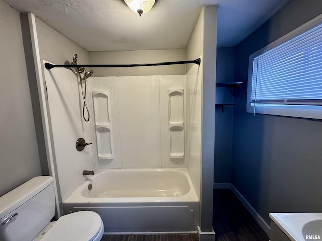 bathroom featuring toilet and shower / tub combination