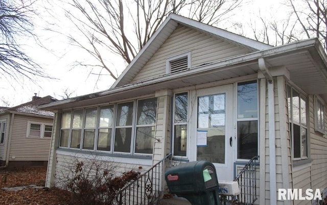 view of front facade with a sunroom