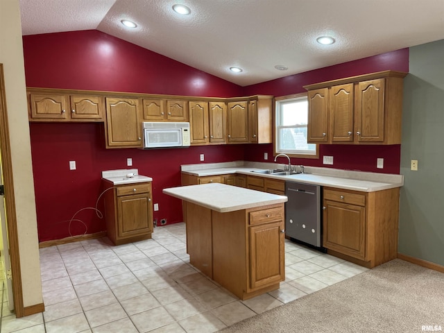 kitchen featuring a center island, lofted ceiling, stainless steel dishwasher, sink, and light tile patterned floors