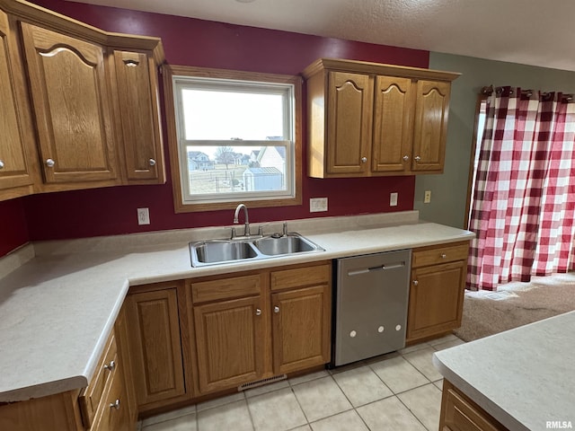 kitchen with light tile patterned floors, sink, and stainless steel dishwasher