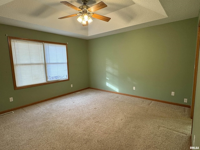 empty room featuring ceiling fan, carpet flooring, and a textured ceiling