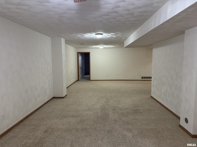 unfurnished room with light colored carpet