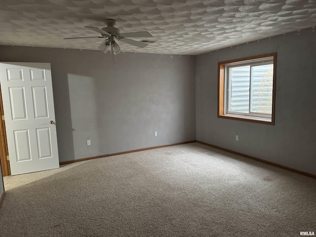 unfurnished room featuring a textured ceiling, carpet flooring, and ceiling fan