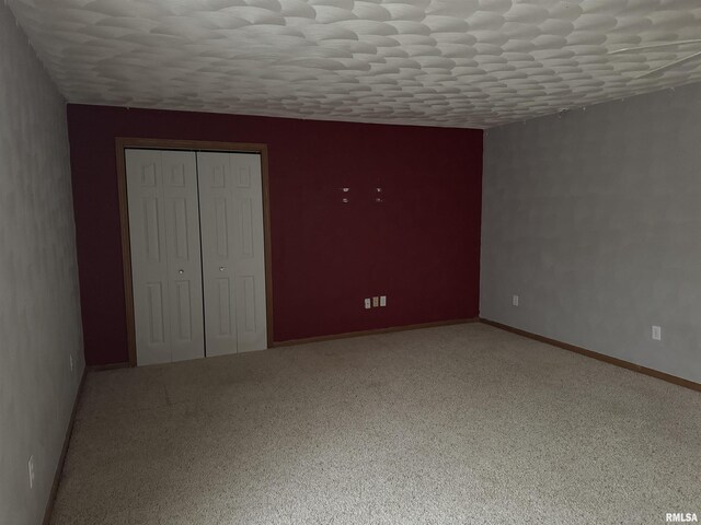 unfurnished bedroom with a closet, carpet flooring, and a textured ceiling