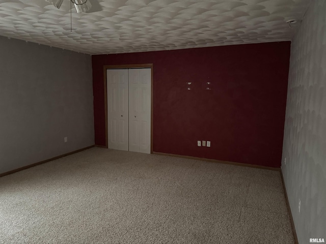 unfurnished bedroom featuring a closet and carpet flooring