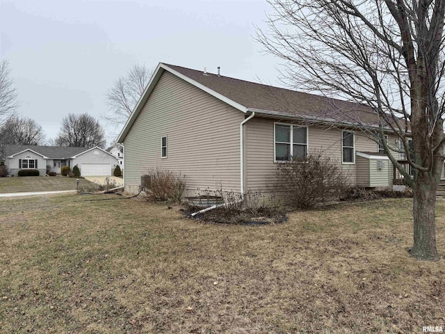 view of property exterior featuring a lawn and a garage