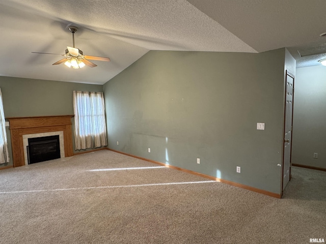 unfurnished living room featuring ceiling fan, a tile fireplace, carpet floors, and lofted ceiling