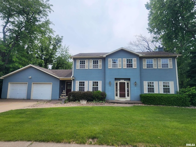591 Breezy Point Dr, Clinton, IA 52732 - colonial inspired home with an attached garage, concrete driveway, a front lawn, and a chimney