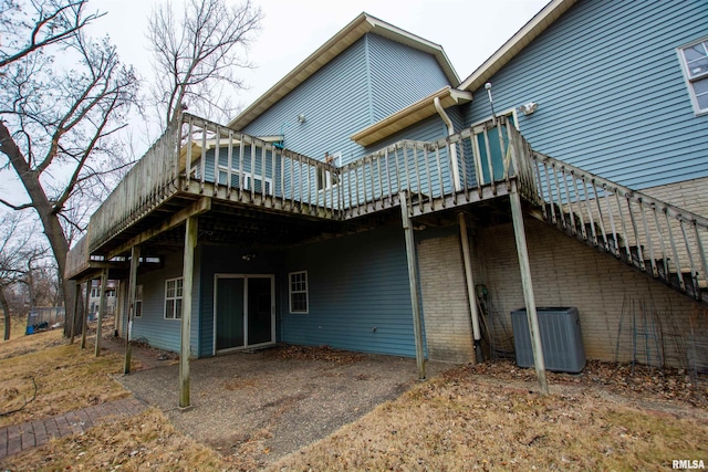 591 Breezy Point Dr, Clinton, IA 52732 - back of house with central AC, a wooden deck, asphalt driveway, and an attached carport