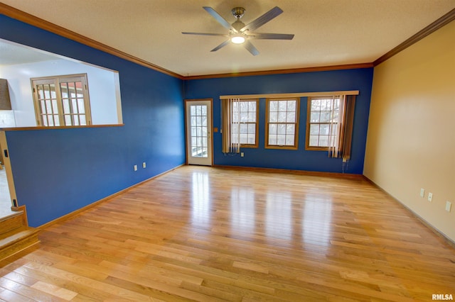 591 Breezy Point Dr, Clinton, IA 52732 - spare room with wood finished floors, ceiling fan, crown molding, and baseboards
