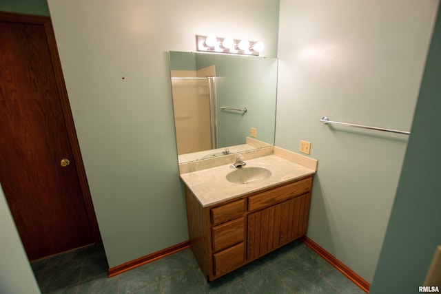 591 Breezy Point Dr, Clinton, IA 52732 - bathroom featuring vanity, a stall shower, and baseboards