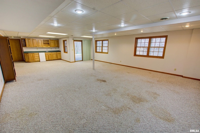 591 Breezy Point Dr, Clinton, IA 52732 - below grade area with baseboards, a drop ceiling, light carpet, and bar